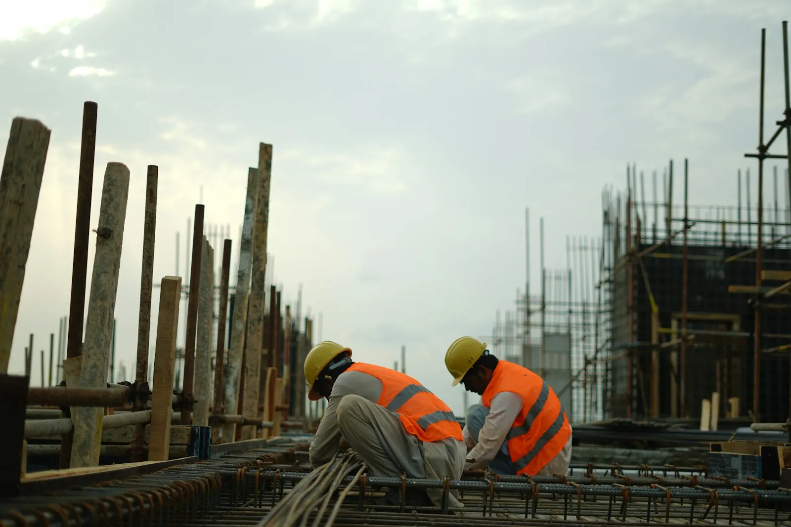 Equipo de profesionales de la reforma con cascos y chalecos de seguridad en obra